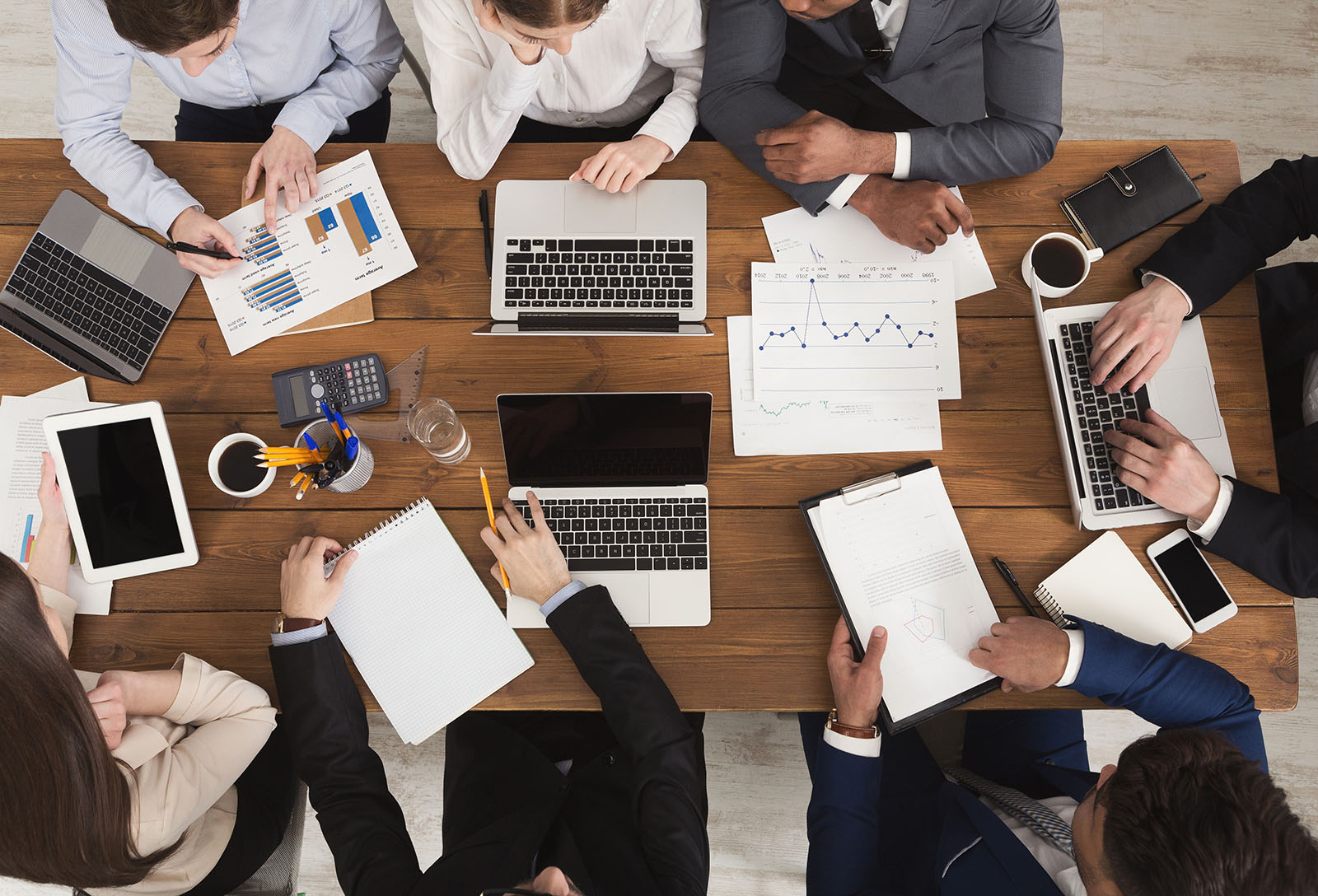 Business team reviewing data and planning around a conference table
