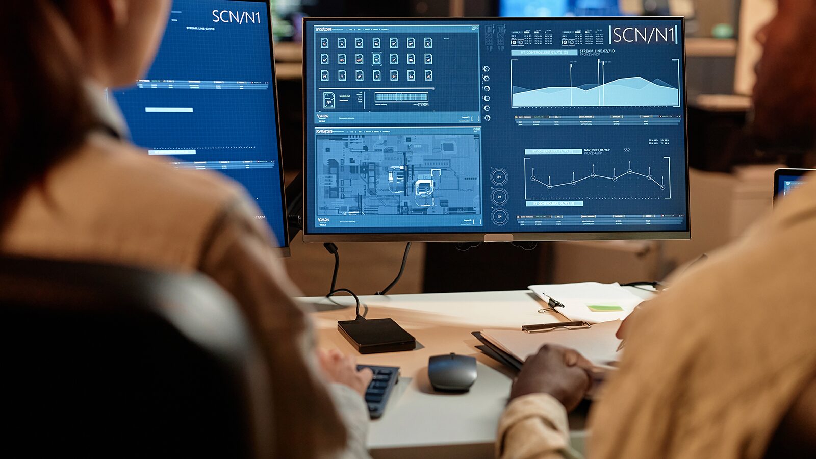 Analysts reviewing data dashboards on a computer